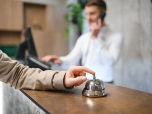 hand-woman-using-hotel-bell.jpg